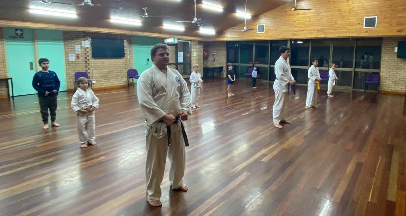 Taekwondo students training together in class
